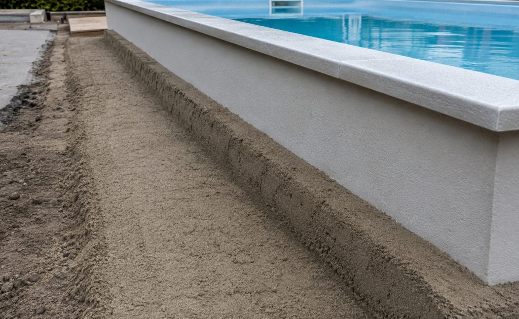 Close up van verdicht zandcement rondom een buitenzwembad